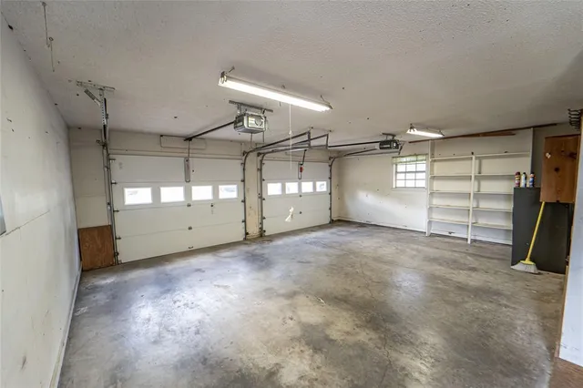 a front view of a house with basket ball court and glass windows