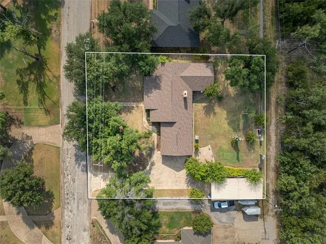 an aerial view of a house with a yard