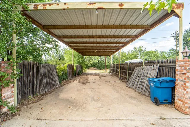 a view of backyard with wooden fence and outdoor seating