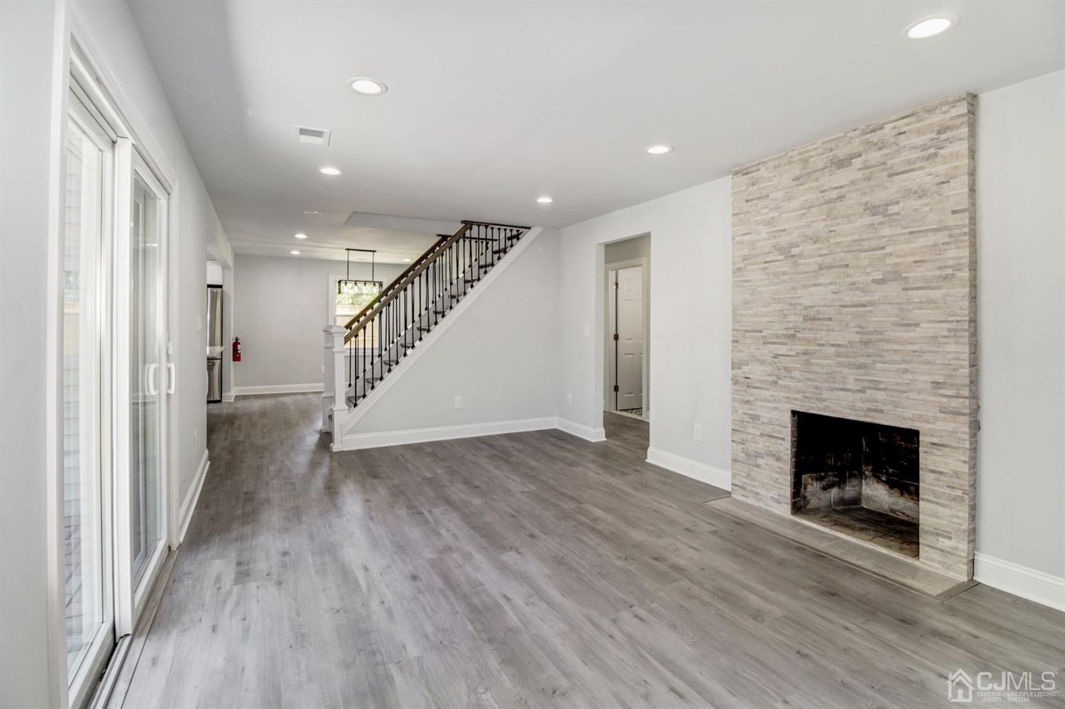 126 Greenbrook Road Green Brook, NJ 08812 - Photo 14 of 36 a view of a livingroom with wooden floor and a fireplace