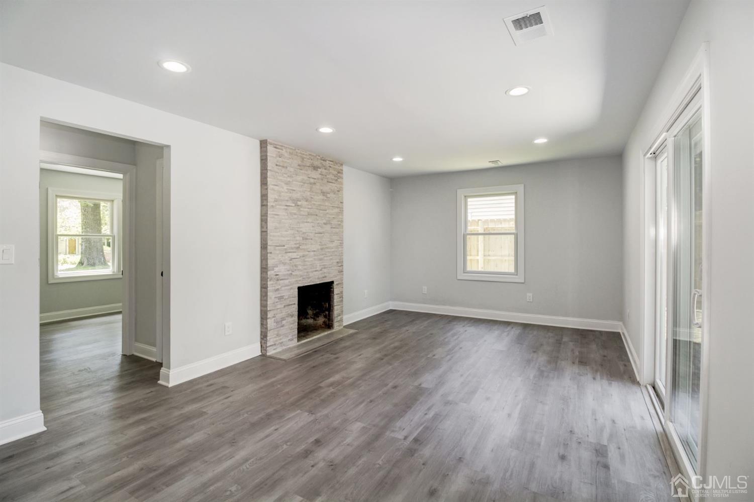 126 Greenbrook Road Green Brook, NJ 08812 - Photo 16 of 36 an empty room with wooden floor and windows