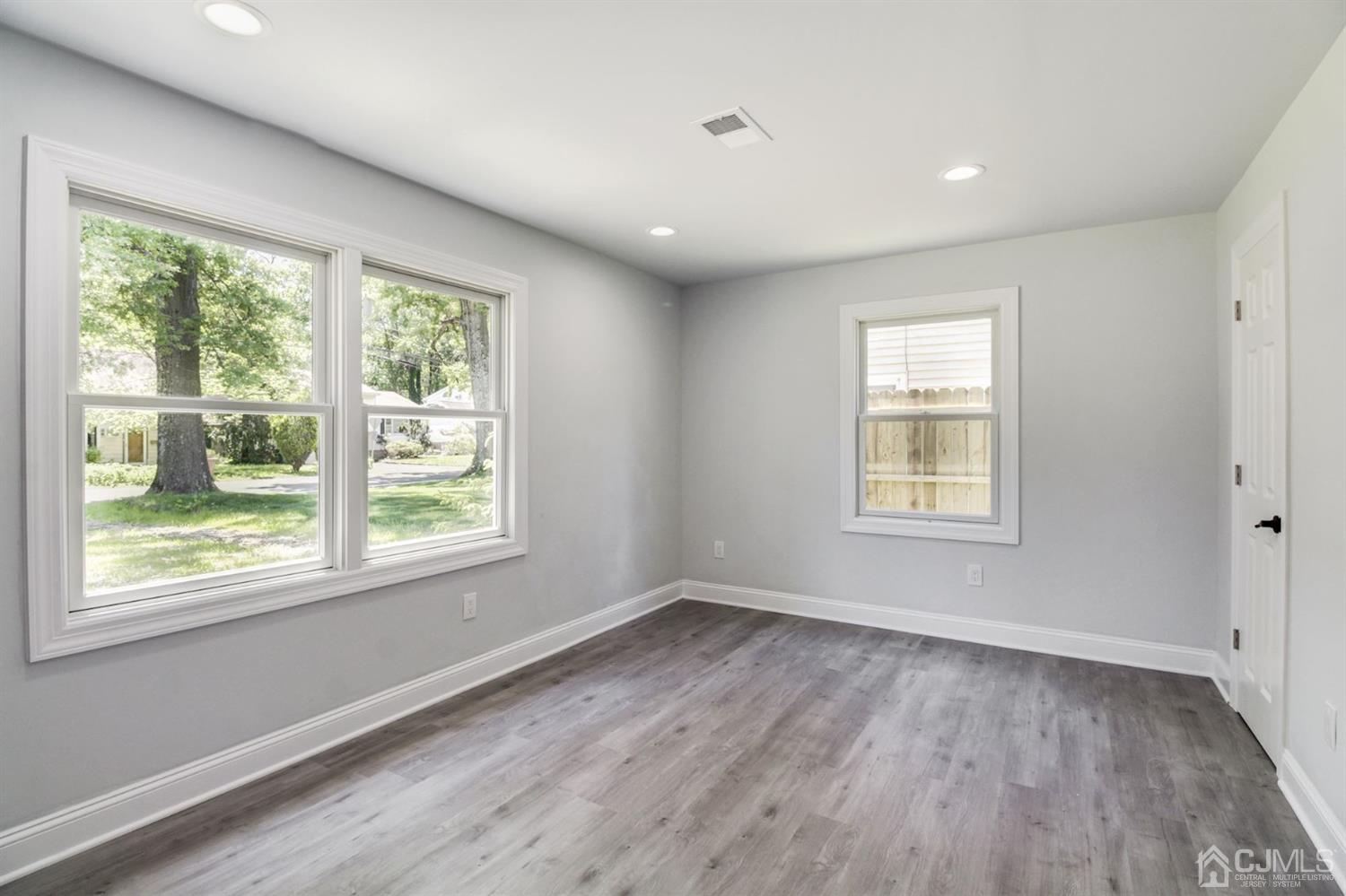 126 Greenbrook Road Green Brook, NJ 08812 - Photo 17 of 36 a view of an empty room with wooden floor and a window