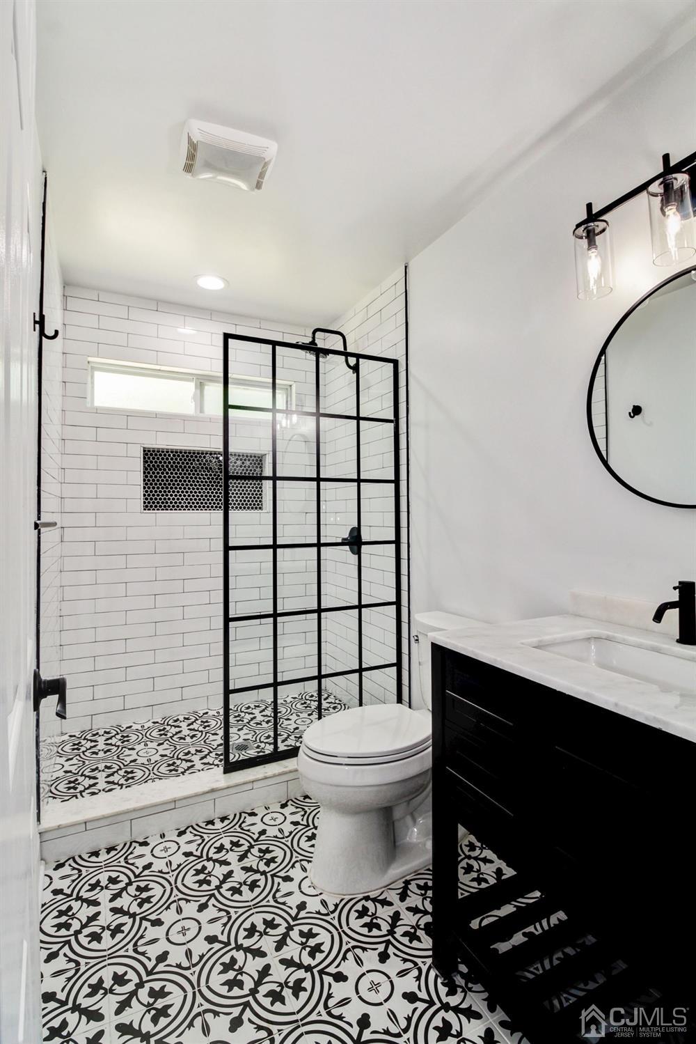 126 Greenbrook Road Green Brook, NJ 08812 - Photo 19 of 36 a bathroom with a sink toilet vanity and shower
