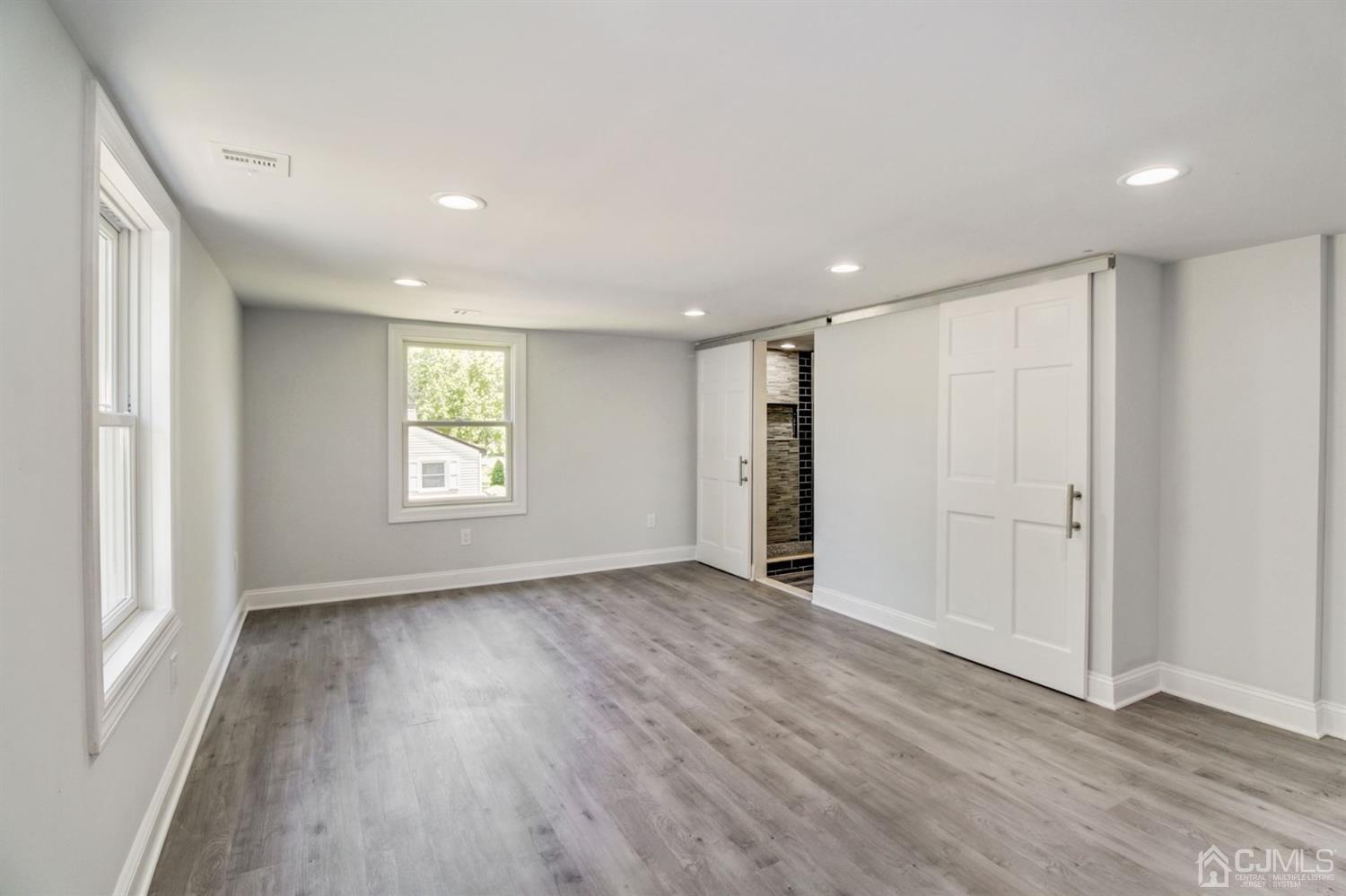 126 Greenbrook Road Green Brook, NJ 08812 - Photo 22 of 36 an empty room with wooden floor and windows