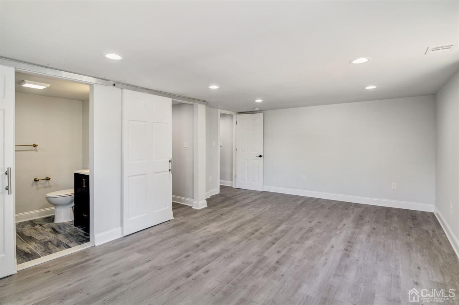 126 Greenbrook Road Green Brook, NJ 08812 - Photo 23 of 36 an empty room with wooden floor and a toilet