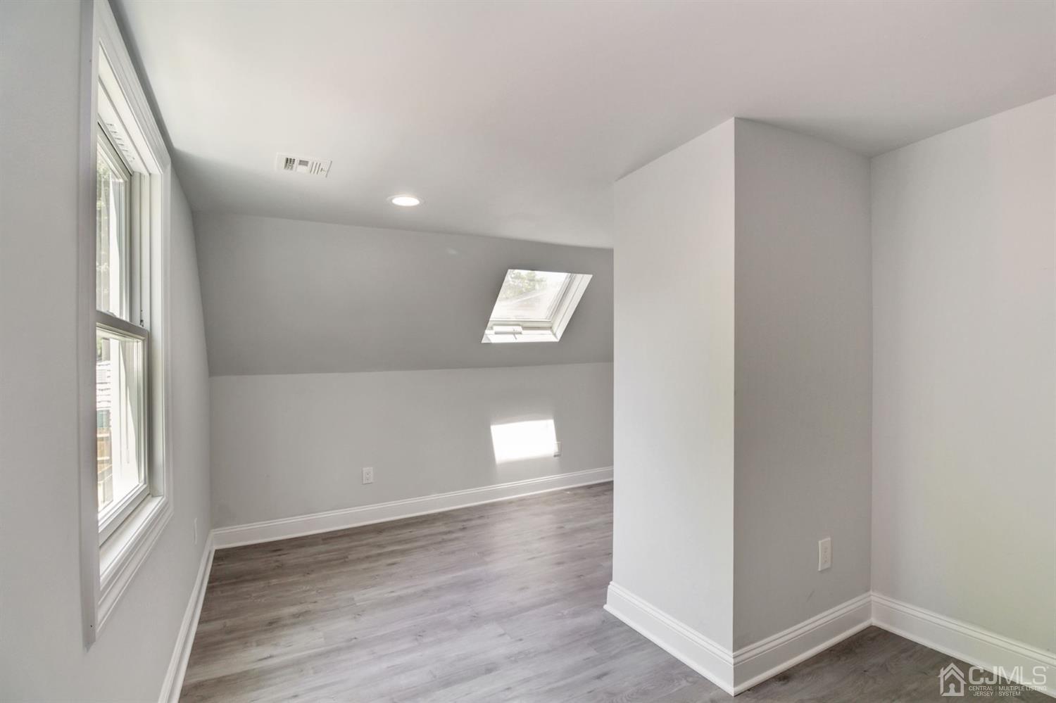 126 Greenbrook Road Green Brook, NJ 08812 - Photo 26 of 36 a view of an empty room with window and wooden floor