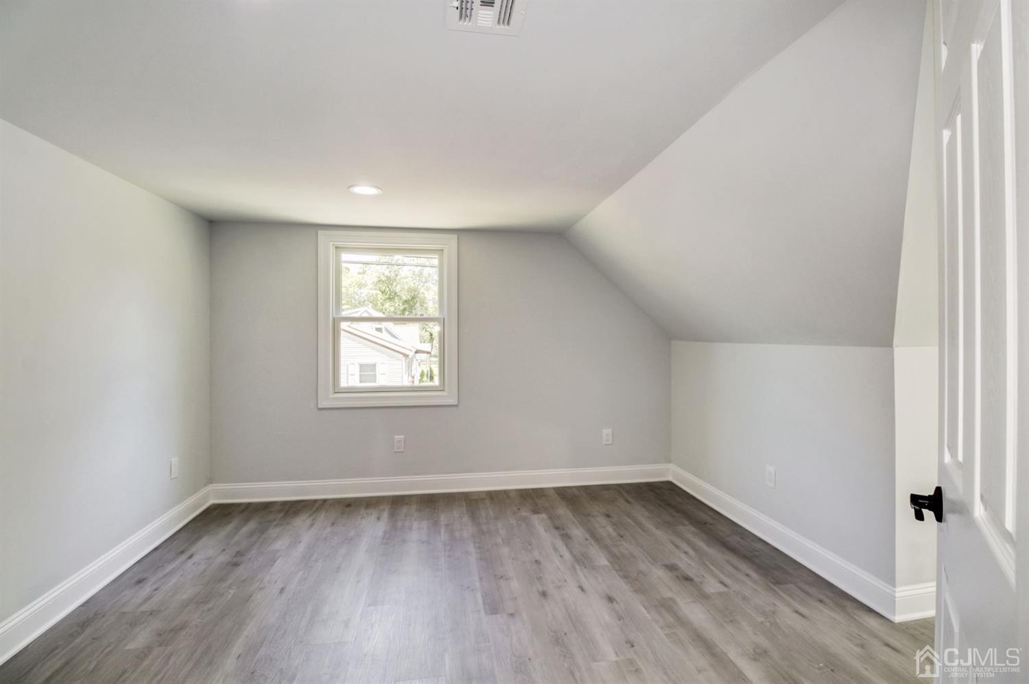 126 Greenbrook Road Green Brook, NJ 08812 - Photo 29 of 36 an empty room with wooden floor and window