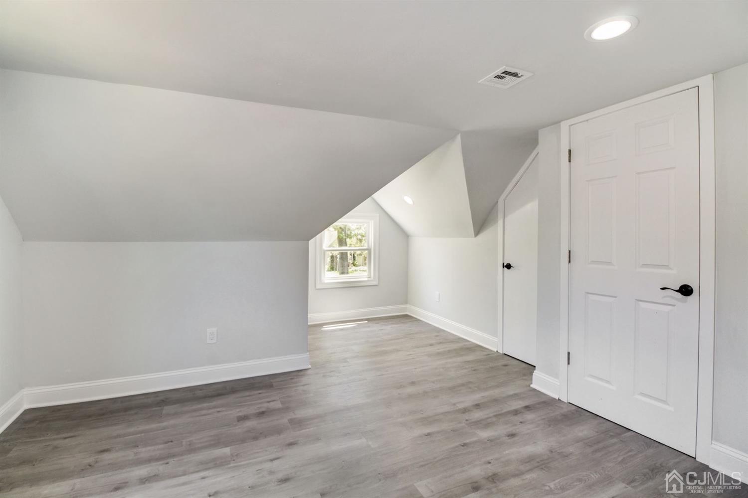 126 Greenbrook Road Green Brook, NJ 08812 - Photo 30 of 36 a view of an empty room with wooden floor and a window