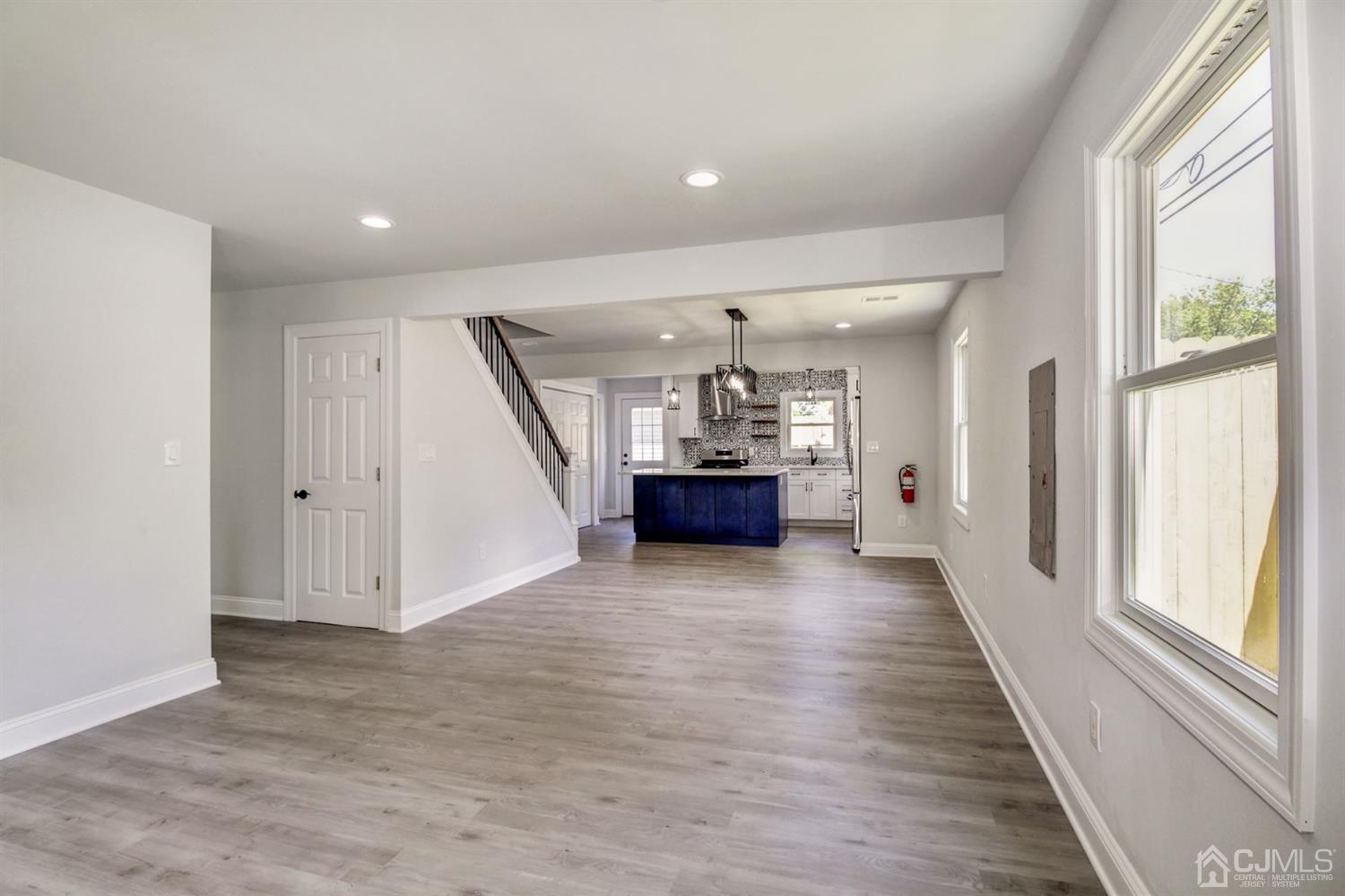 126 Greenbrook Road Green Brook, NJ 08812 - Photo 4 of 36 an empty room with wooden floor and windows