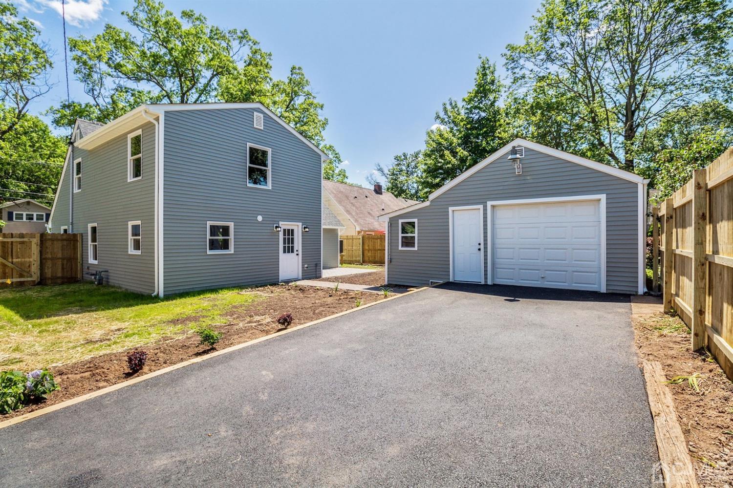 126 Greenbrook Road Green Brook, NJ 08812 - Photo 33 of 36 a front view of a house with a yard and garage