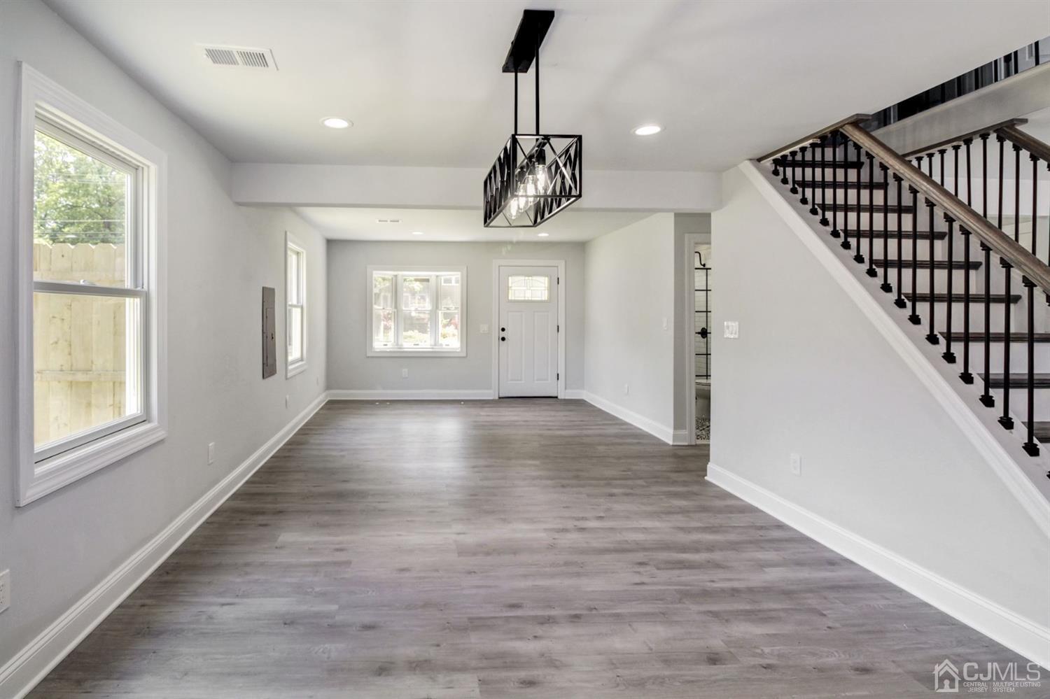 126 Greenbrook Road Green Brook, NJ 08812 - Photo 7 of 36 a view of an empty room with wooden floor and windows