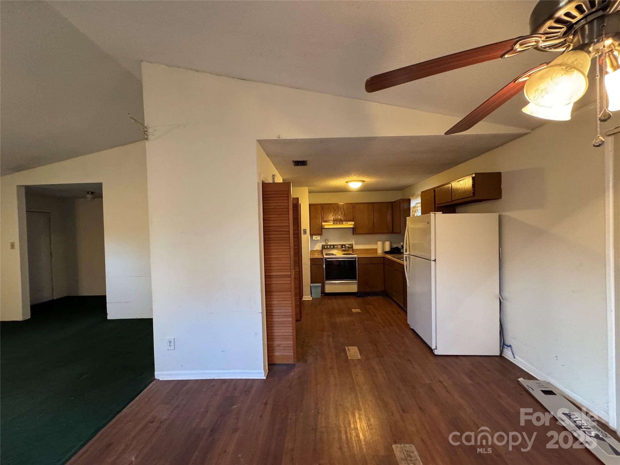 4770 Needmore Road Woodleaf, NC 27054 - Photo 4 of 19 a view of a utility room with closet and wooden floor