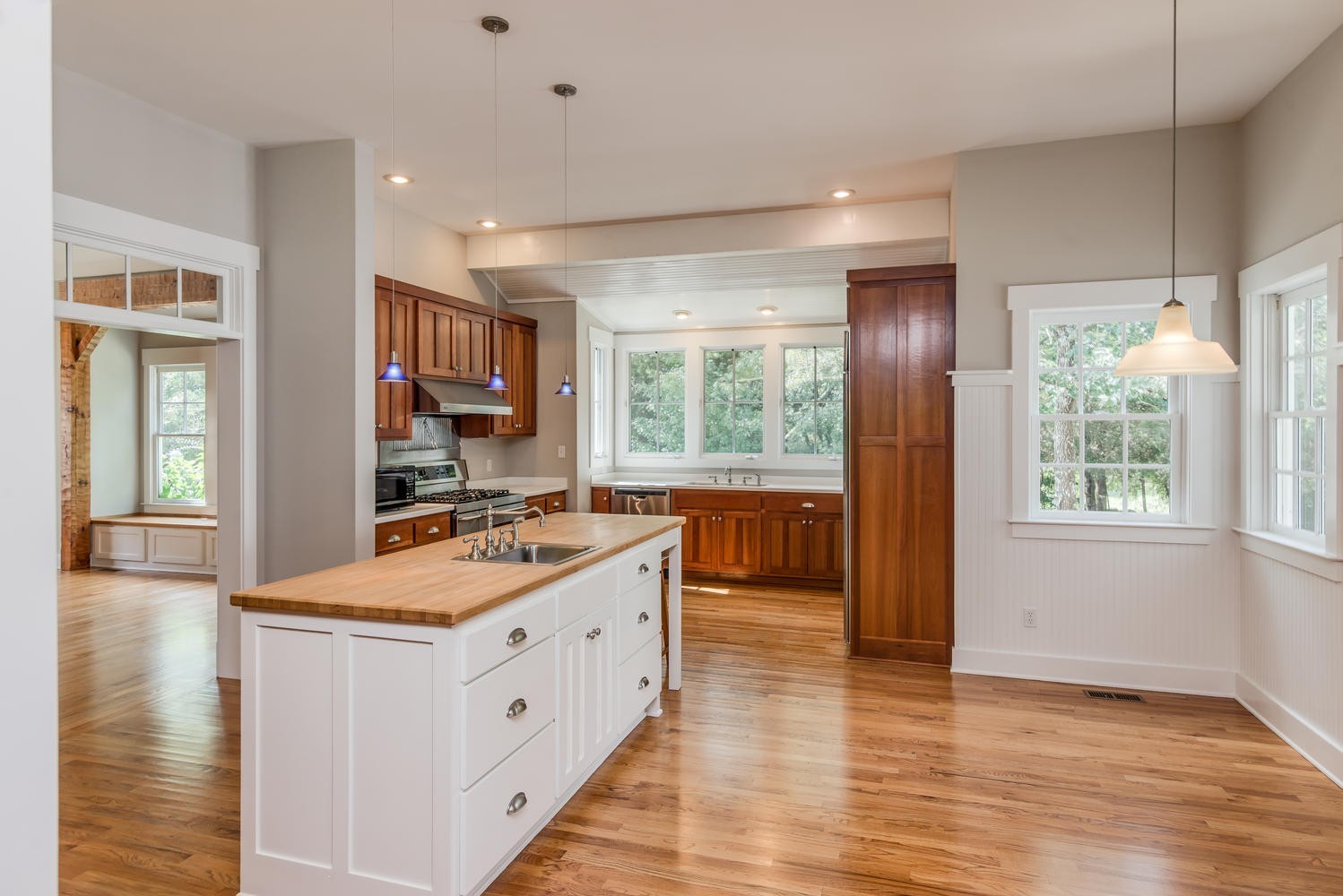 1091 Tulloss Road Franklin, TN 37067 - Photo 19 of 52 a large white kitchen with a large window a sink and wooden floor