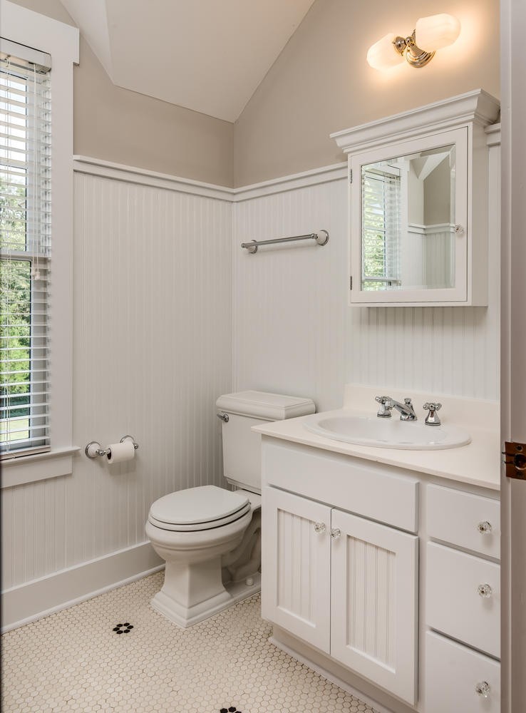 1091 Tulloss Road Franklin, TN 37067 - Photo 38 of 52 a bathroom with a toilet a sink a mirror a window and vanity