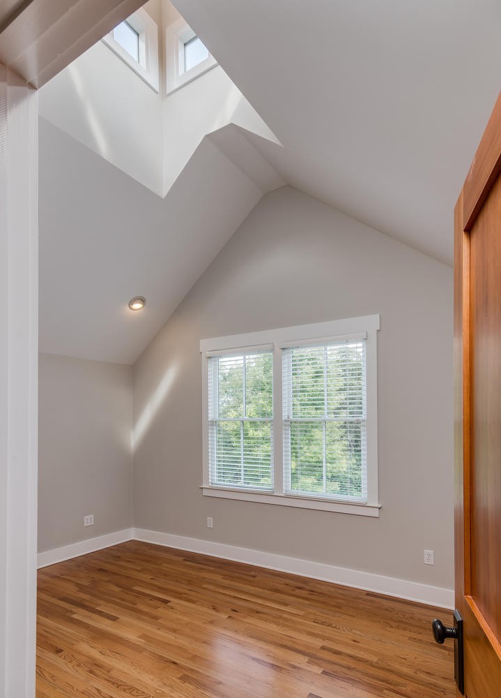 1091 Tulloss Road Franklin, TN 37067 - Photo 40 of 52 a view of an empty room with wooden floor and a window