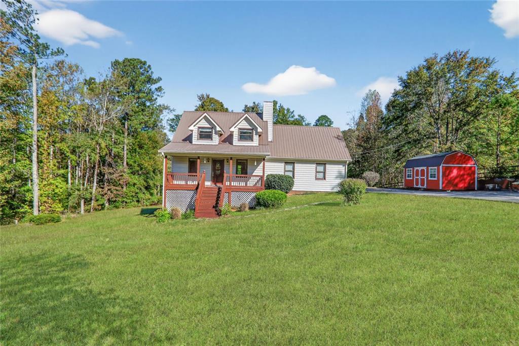 a front view of a house with a yard and trees