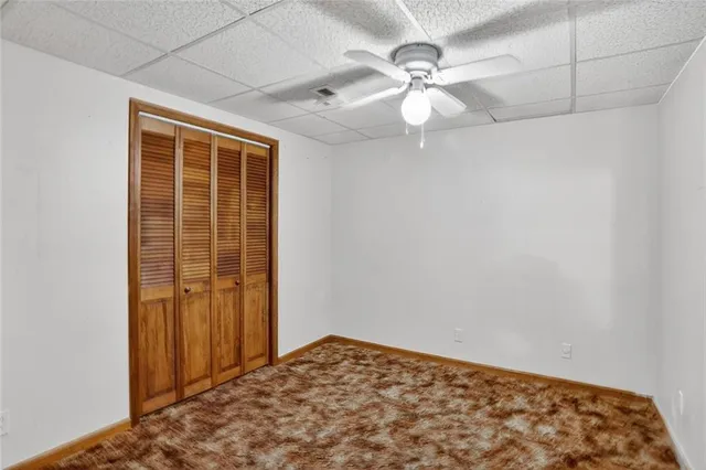 a view of a livingroom with a ceiling fan and window