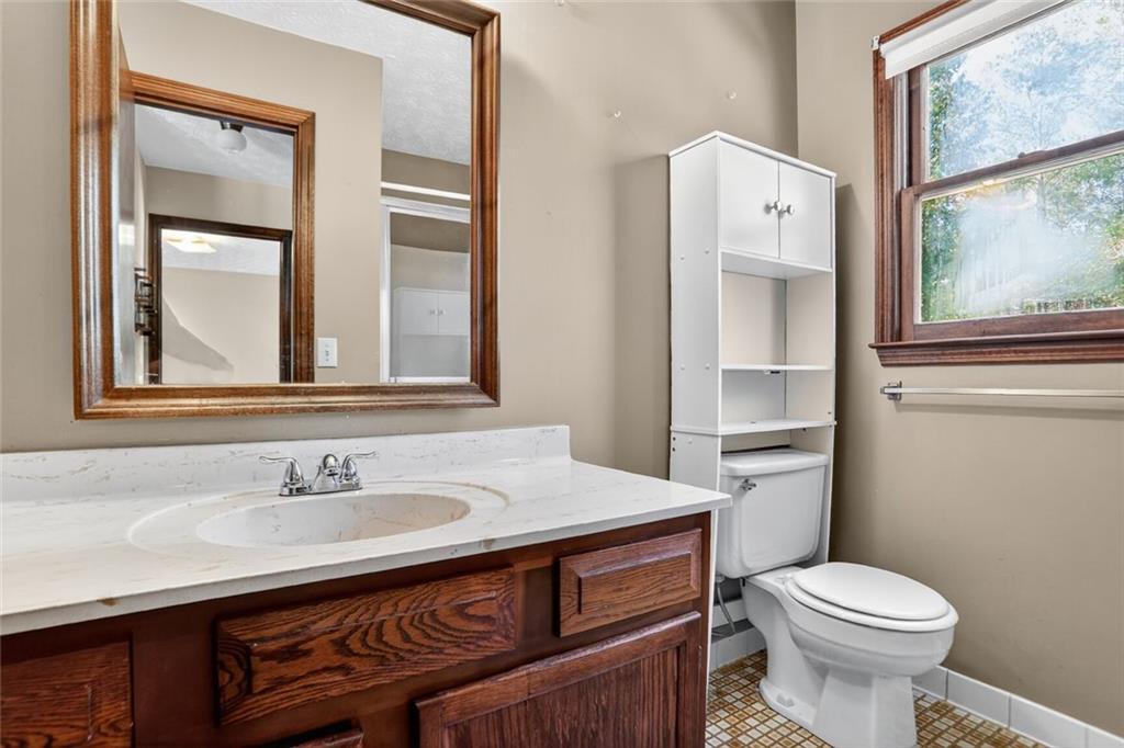 137 Fawn Drive Villa Rica, GA 30180 - Photo 9 of 29 a bathroom with a sink toilet and mirror