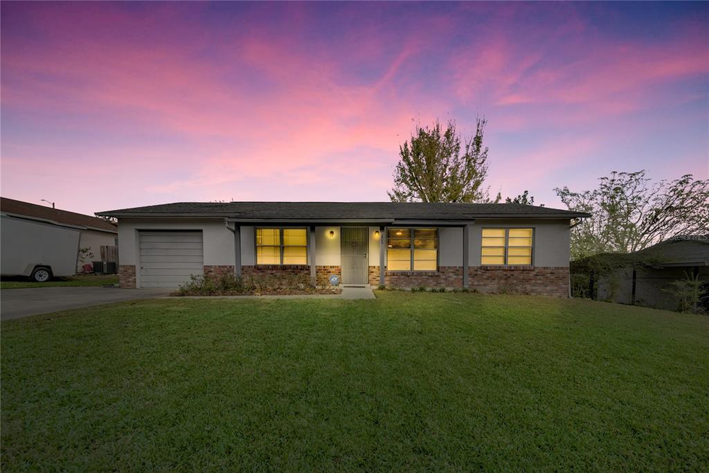 a front view of a house with a garden