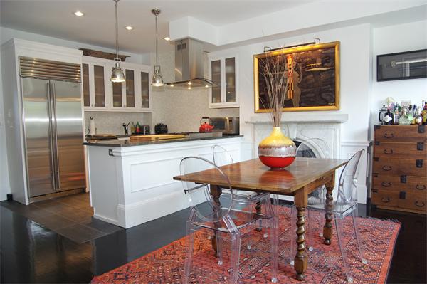 35 Upton Street, Unit 3 Boston, MA 02118 - Photo 8 of 15 a kitchen with stainless steel appliances kitchen island granite countertop a sink cabinets and wooden floor