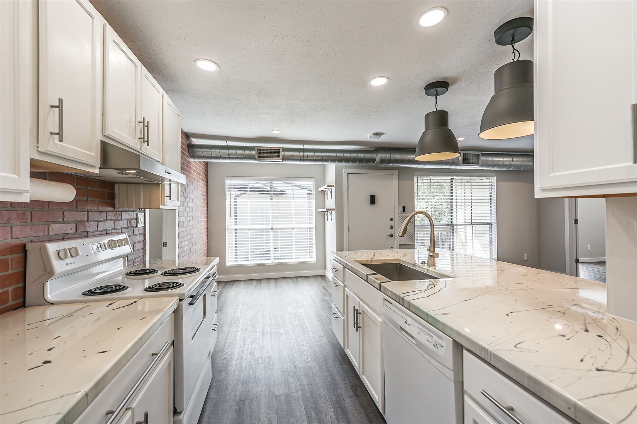 1500 Bay Area Boulevard, Unit 294 Houston, TX 77058 - Photo 9 of 36 a kitchen with granite countertop a sink stainless steel appliances and cabinets