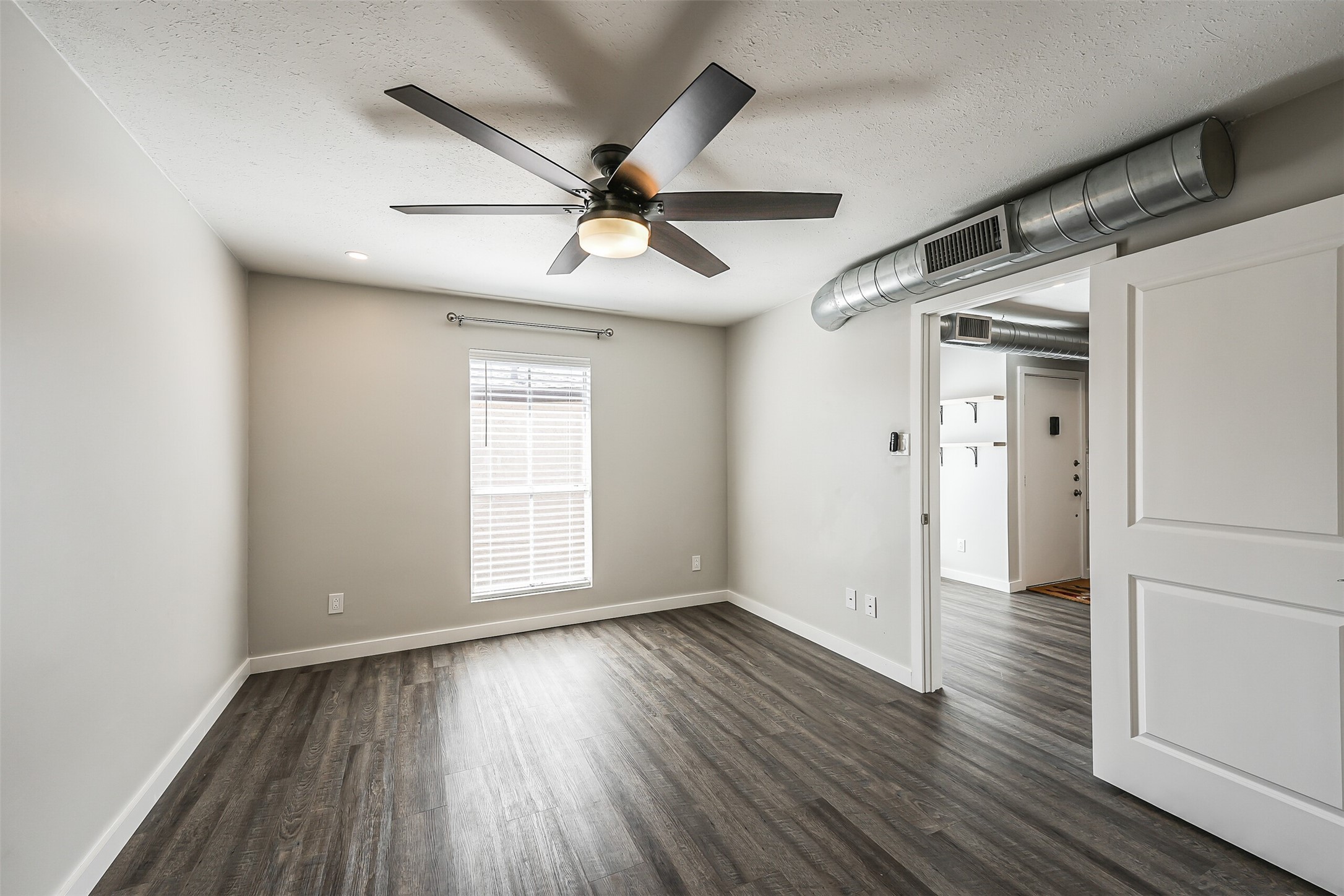 1500 Bay Area Boulevard, Unit 294 Houston, TX 77058 - Photo 12 of 36 a view of empty room with wooden floor and fan