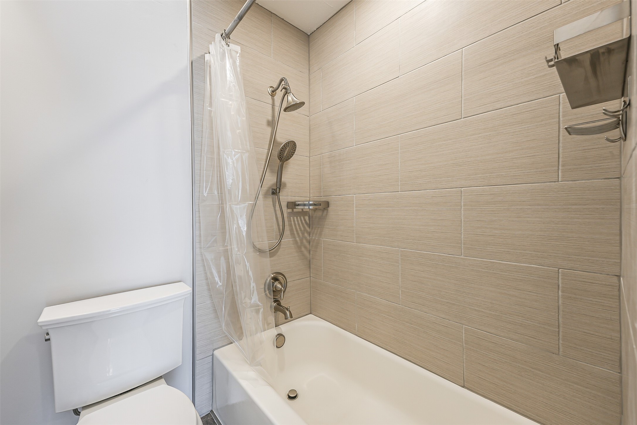 1500 Bay Area Boulevard, Unit 294 Houston, TX 77058 - Photo 16 of 36 a bathroom with a sink a toilet and shower