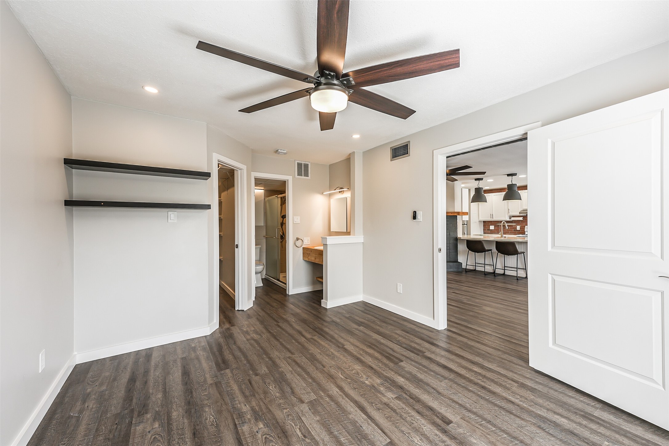 1500 Bay Area Boulevard, Unit 294 Houston, TX 77058 - Photo 18 of 36 a view of a hallway with wooden floor and a ceiling fan