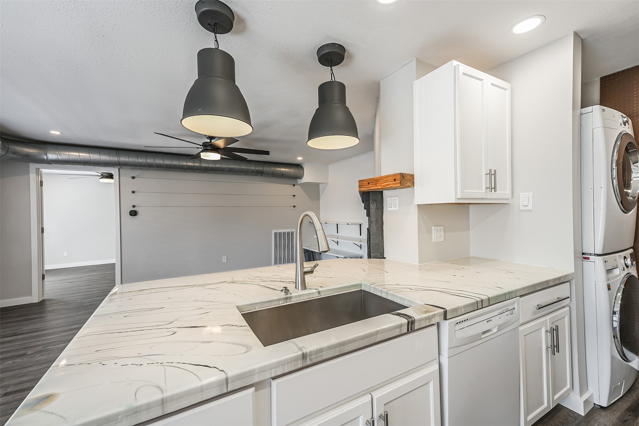 1500 Bay Area Boulevard, Unit 294 Houston, TX 77058 - Photo 6 of 36 a kitchen with stainless steel appliances a sink a refrigerator and cabinets