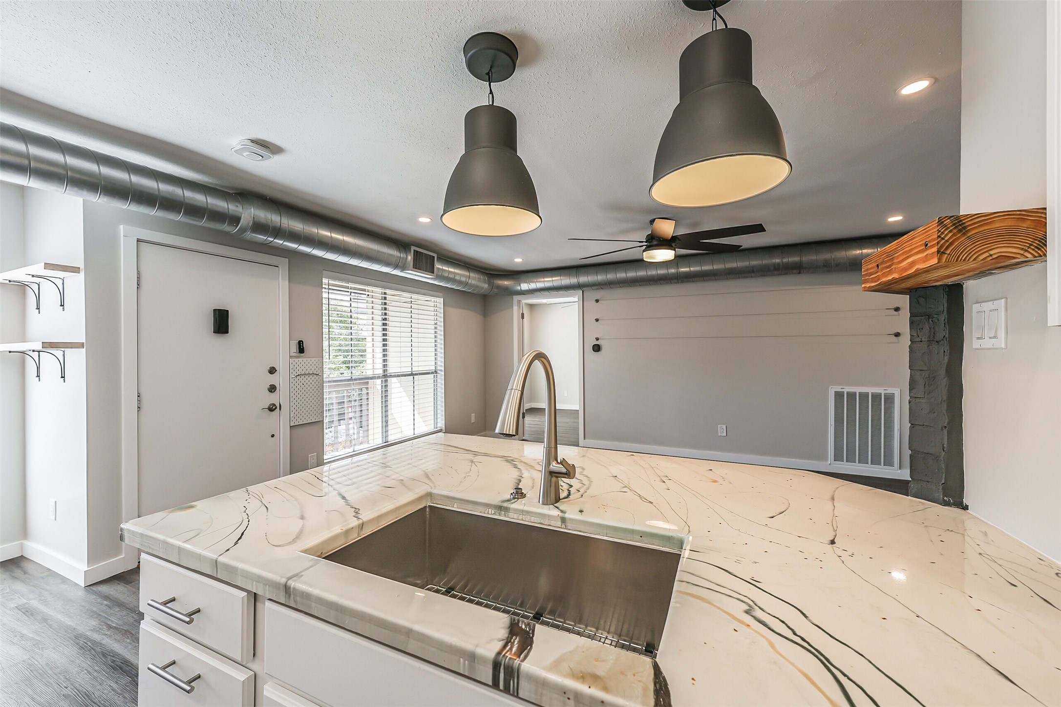 1500 Bay Area Boulevard, Unit 294 Houston, TX 77058 - Photo 7 of 36 a kitchen with a sink a stove and chairs