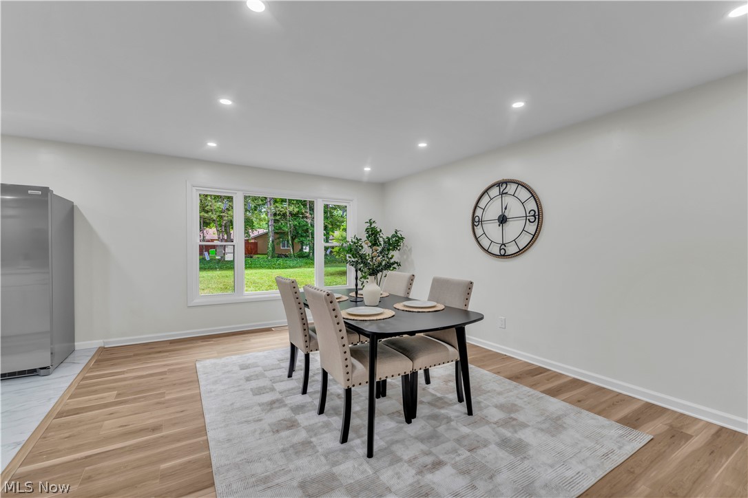 10763 Gate Post Road Strongsville, OH 44149 - Photo 23 of 45 Spacious dining area featuring large windows, recessed lighting, light wood-finish flooring, and a neutral color palette