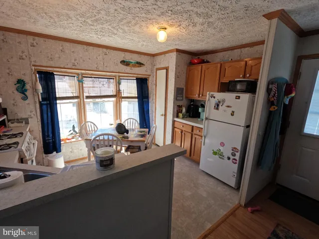a dining room with furniture and large window