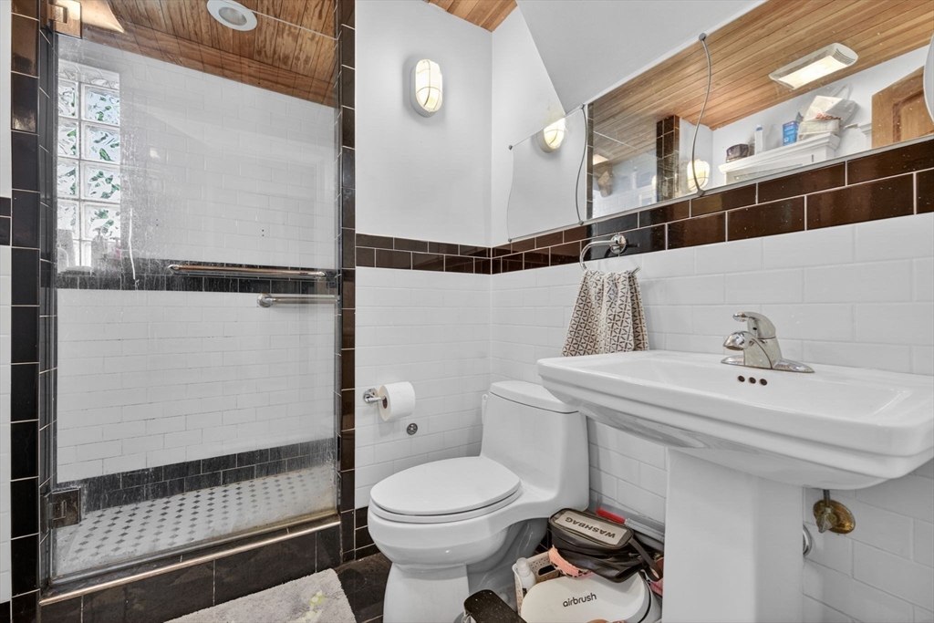 1800 Columbia Road, Unit 6 Boston, MA 02127 - Photo 8 of 11 a bathroom with a sink toilet and shower