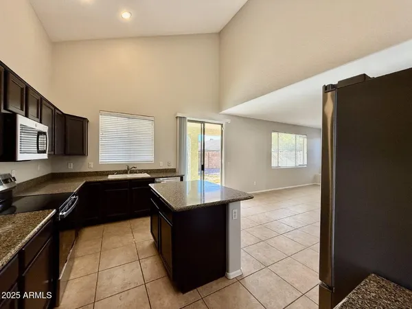 a kitchen with a sink and a stove top oven