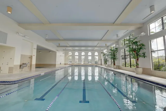 a view of a livingroom with furniture and a large mirror