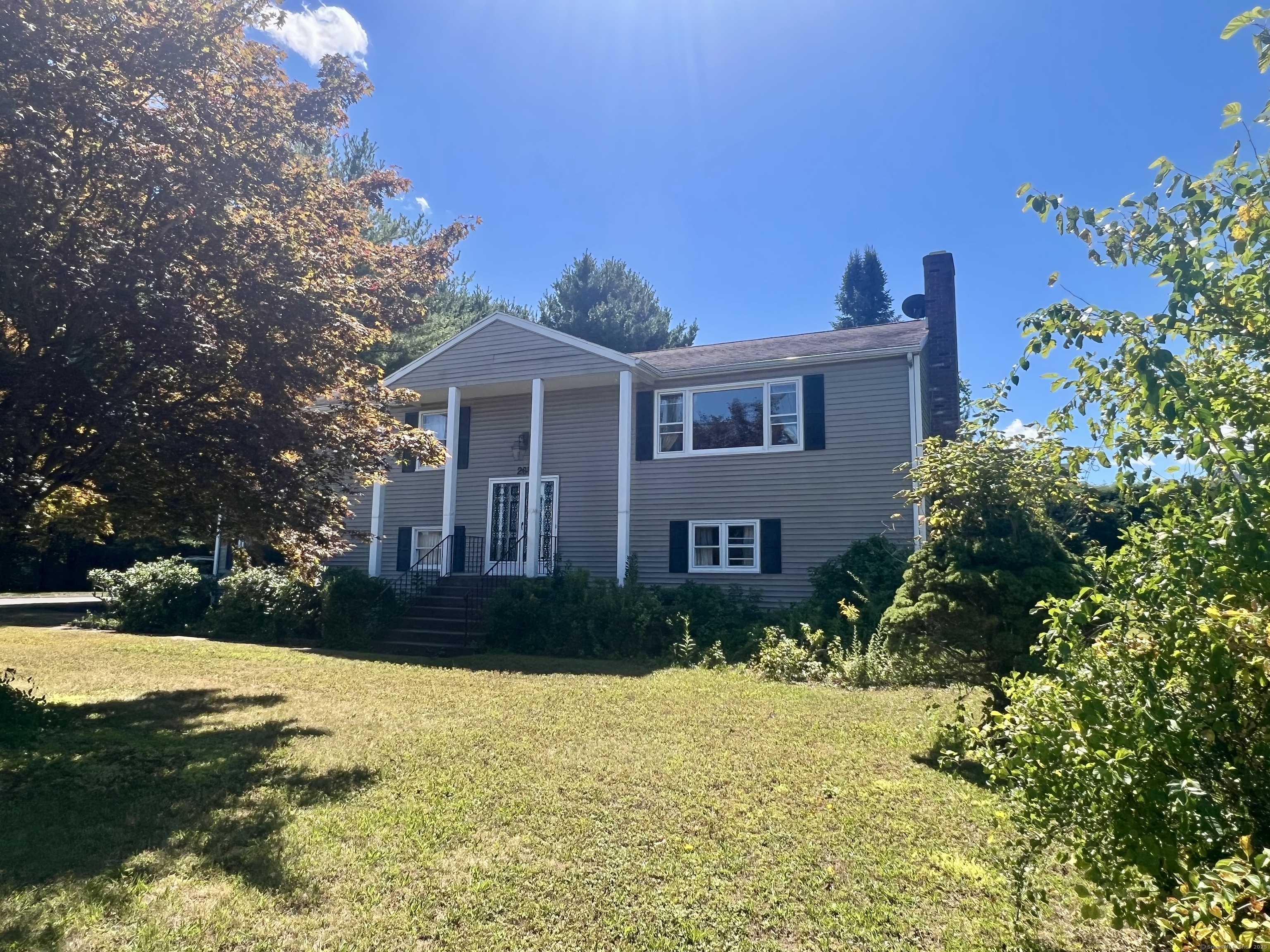 a front view of house with yard and green space
