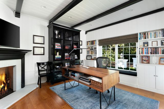 a living room with furniture a fireplace and a flat screen tv
