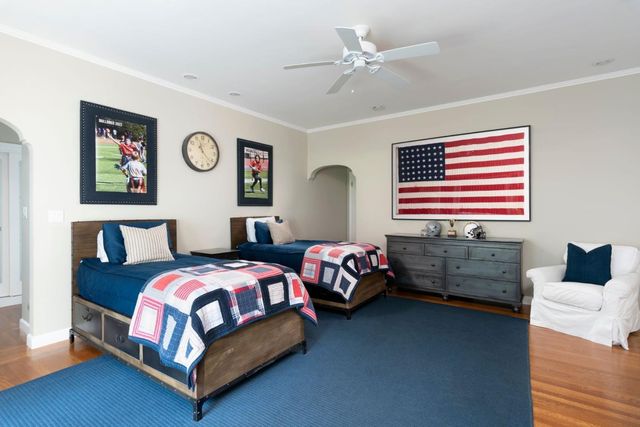 a bedroom with a bed and a chandelier