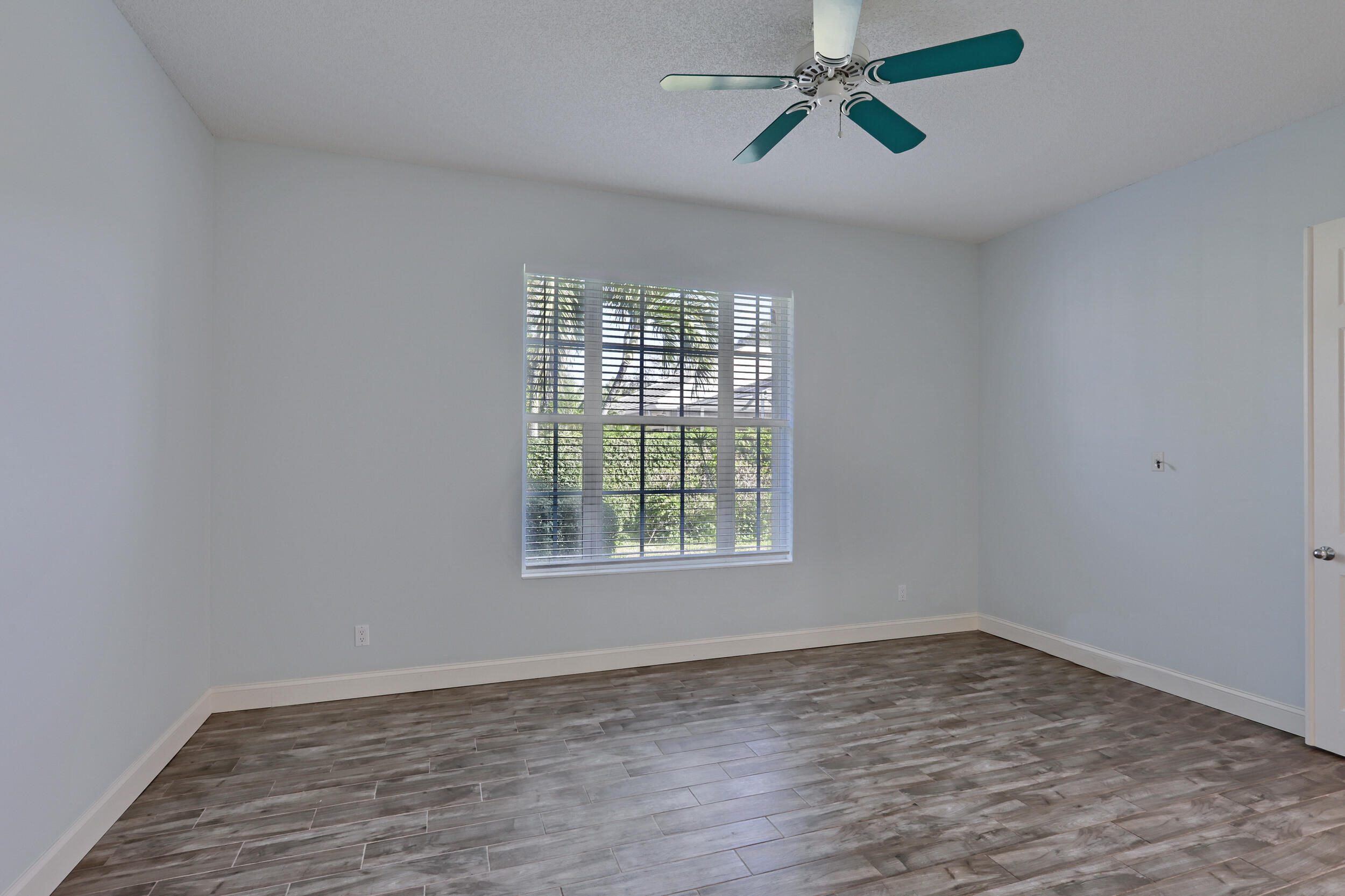 8452 Beaconhill Road Palm Beach Gardens, FL 33410 - Photo 12 of 40 wooden floor in an empty room with a window