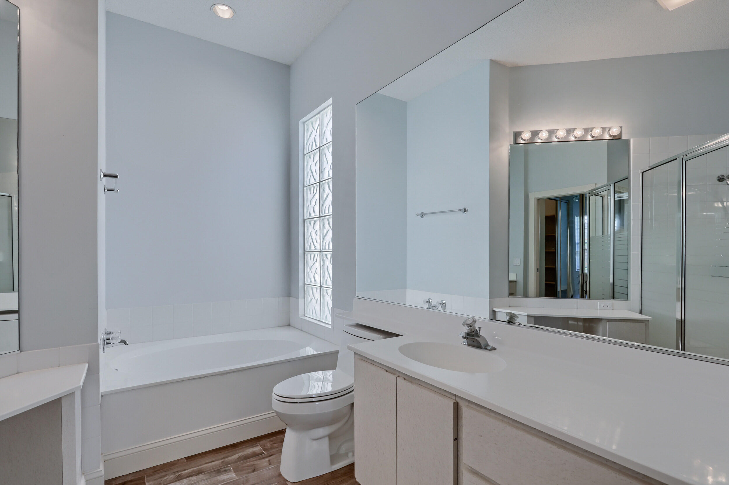 8452 Beaconhill Road Palm Beach Gardens, FL 33410 - Photo 16 of 40 a bathroom with a sink a toilet and shower