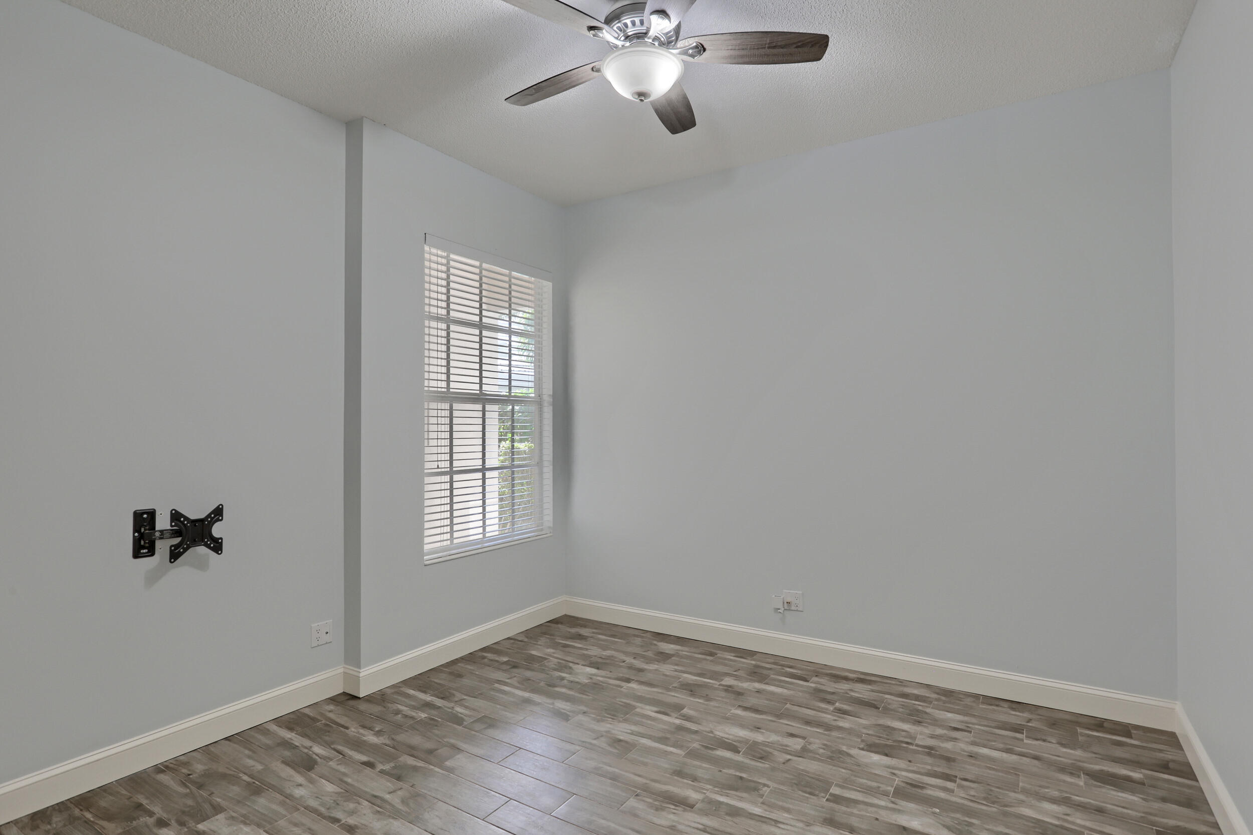 8452 Beaconhill Road Palm Beach Gardens, FL 33410 - Photo 20 of 40 an empty room with windows and fan