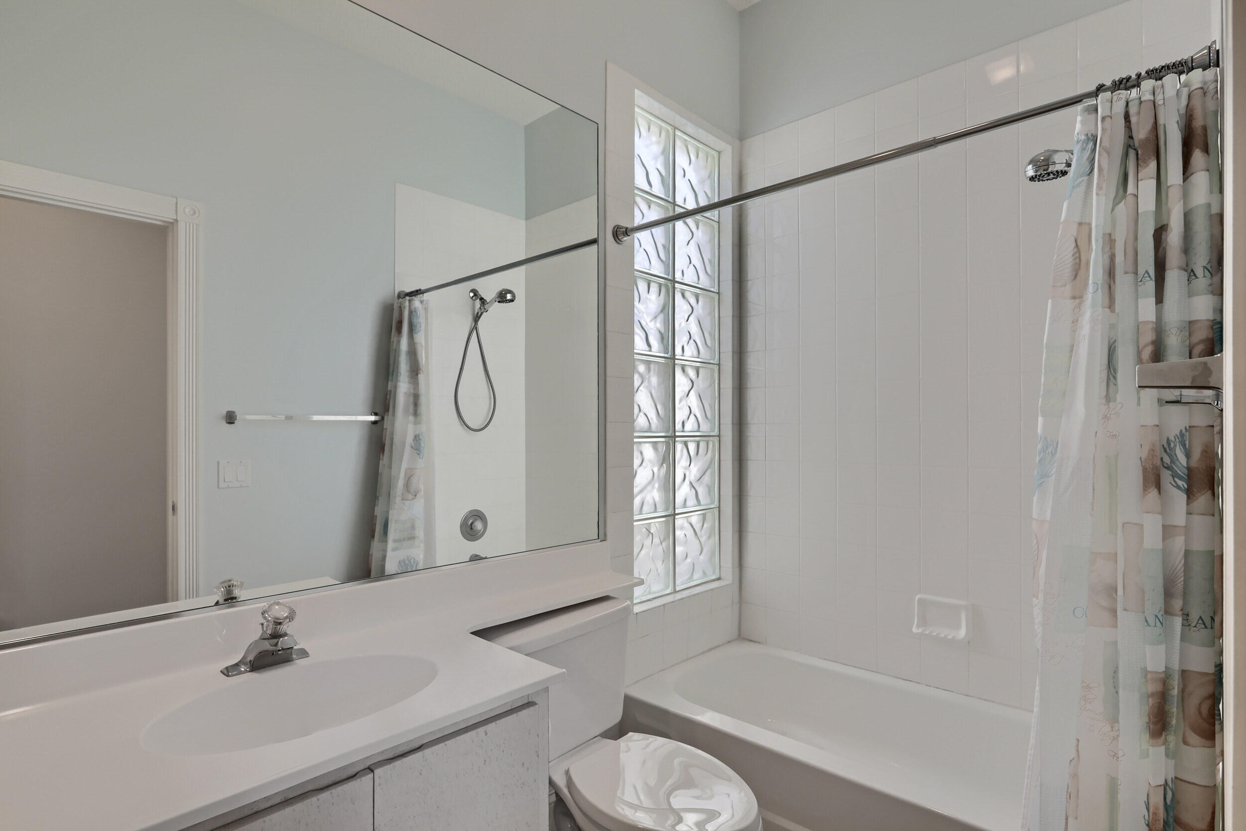 8452 Beaconhill Road Palm Beach Gardens, FL 33410 - Photo 24 of 40 a bathroom with a granite countertop sink a toilet and shower
