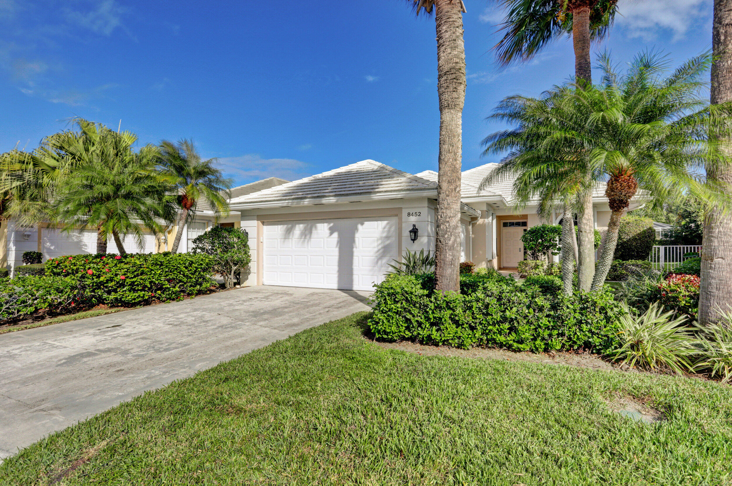 8452 Beaconhill Road Palm Beach Gardens, FL 33410 - Photo 35 of 40 a front view of a house with a garden