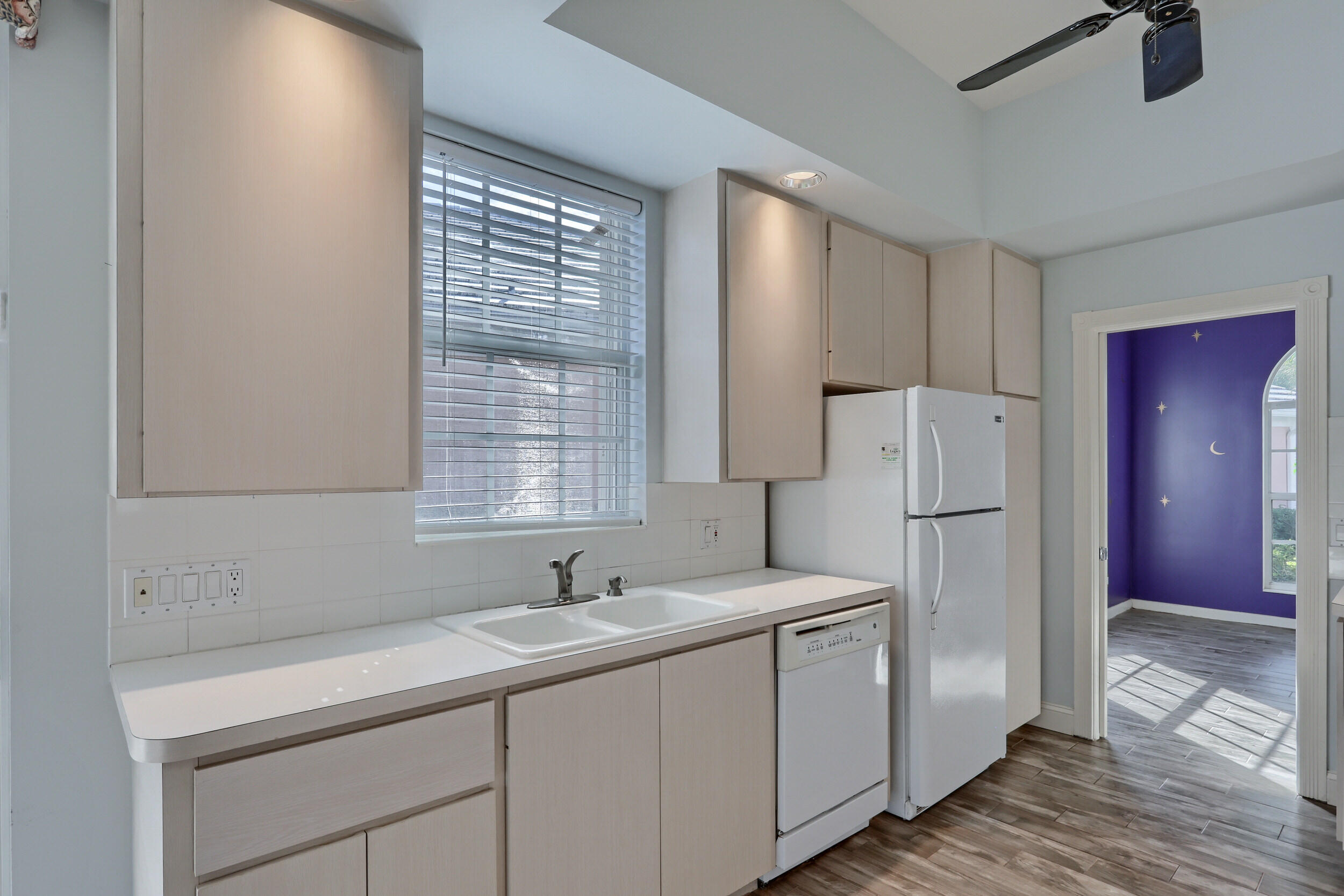 8452 Beaconhill Road Palm Beach Gardens, FL 33410 - Photo 5 of 40 a kitchen with a sink cabinets stainless steel appliances and a window
