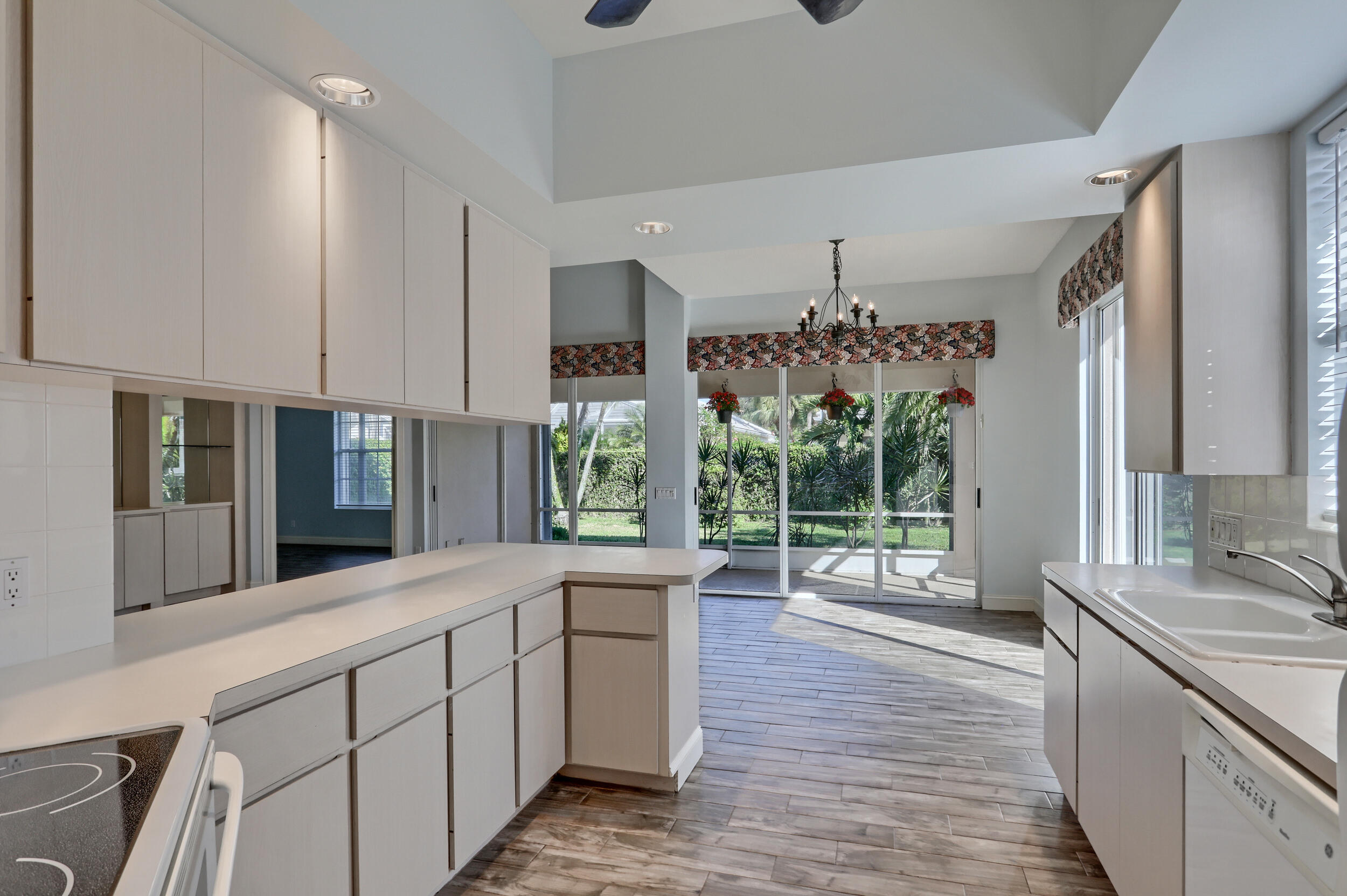 8452 Beaconhill Road Palm Beach Gardens, FL 33410 - Photo 6 of 40 a large kitchen with kitchen island granite countertop a large window and stainless steel appliances