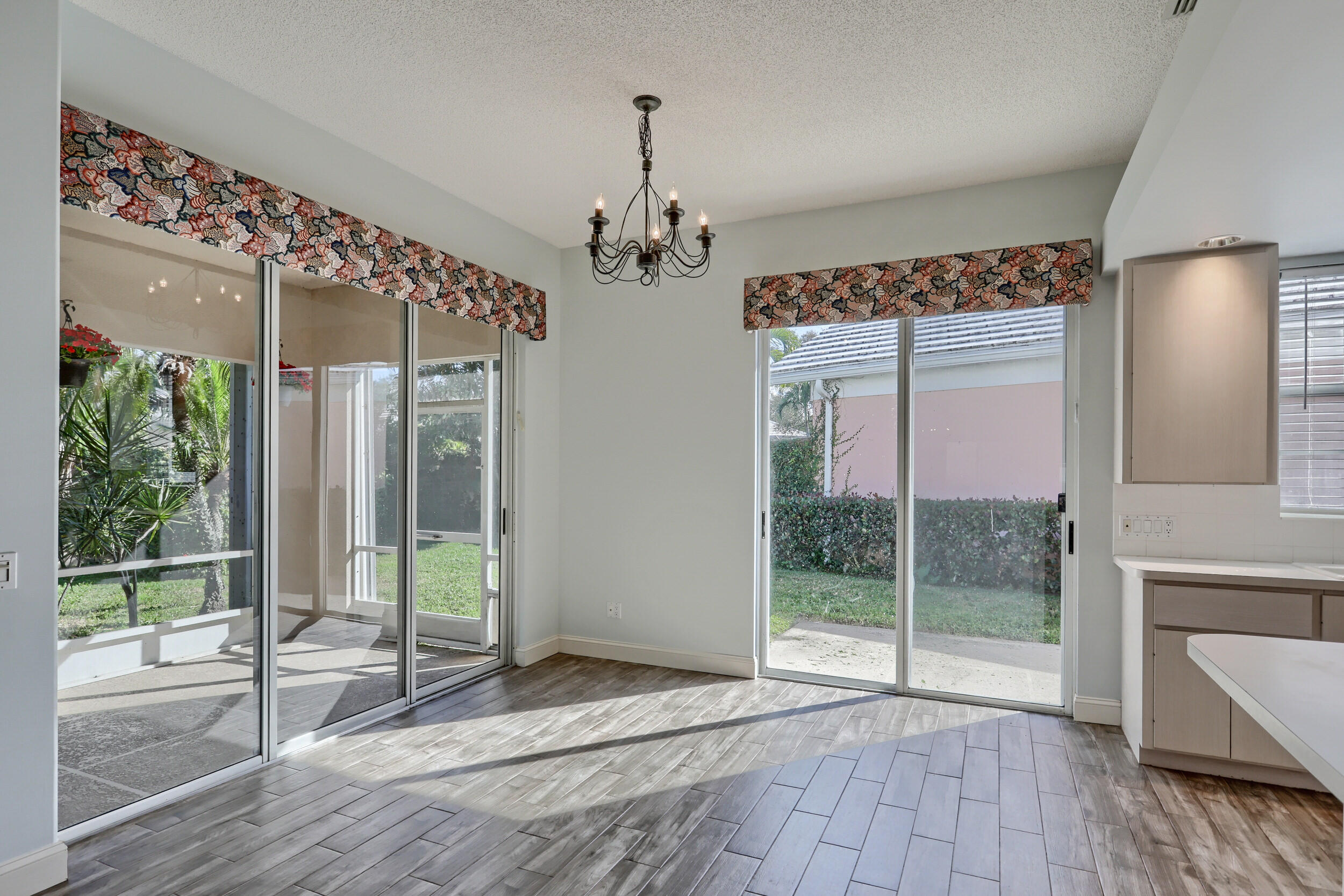 8452 Beaconhill Road Palm Beach Gardens, FL 33410 - Photo 7 of 40 a view of a room with wooden floor and windows