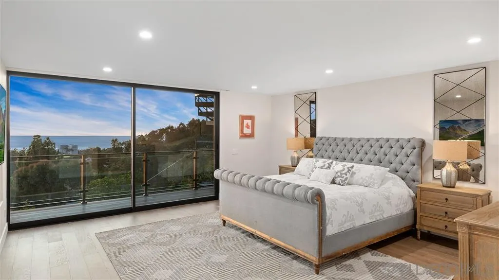 1631 Marisma Way La Jolla, CA 92037 - Photo 15 of 25 a bedroom with a bed and large mirror