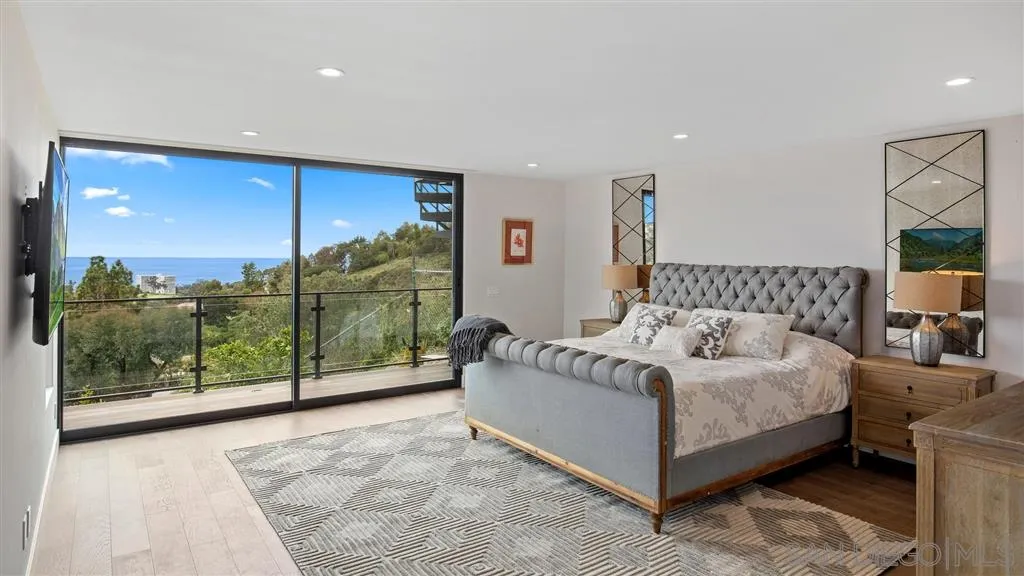 1631 Marisma Way La Jolla, CA 92037 - Photo 22 of 25 a bedroom with a bed and large window