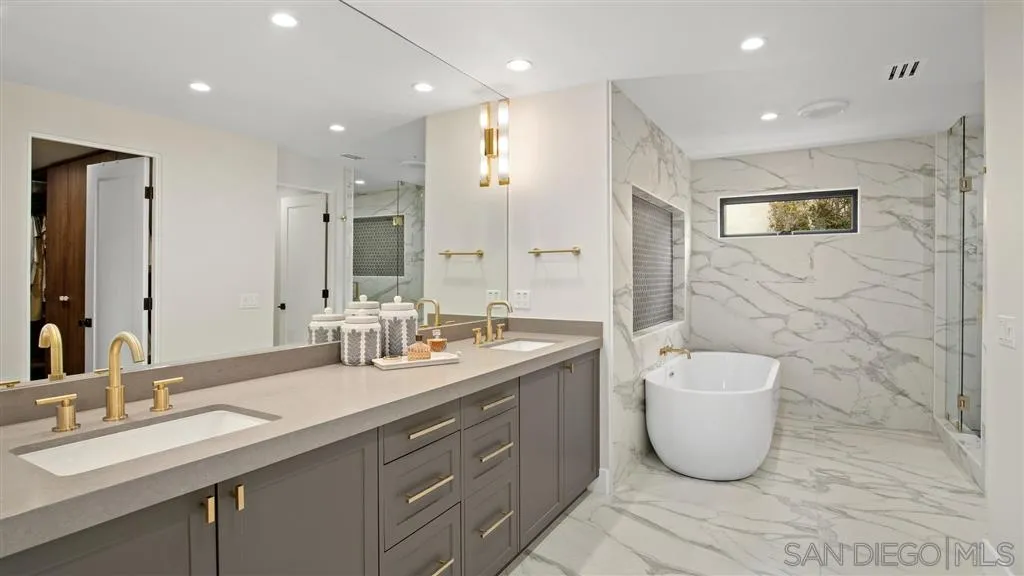 1631 Marisma Way La Jolla, CA 92037 - Photo 23 of 25 a spacious bathroom with a double vanity sink mirror and bathtub