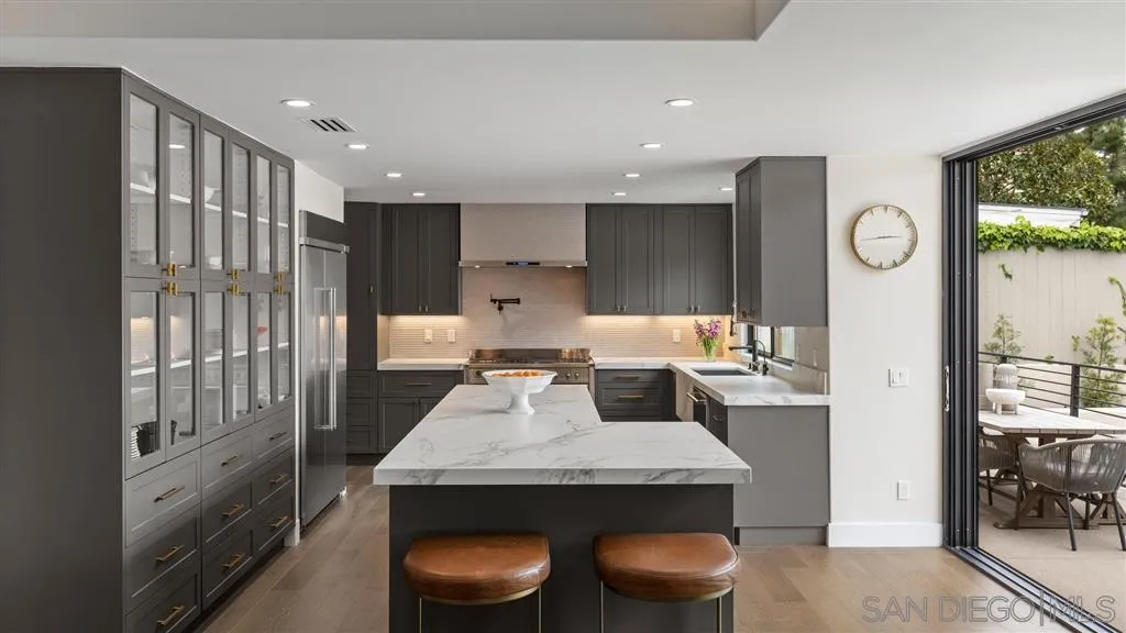 1631 Marisma Way La Jolla, CA 92037 - Photo 9 of 25 a large kitchen with a table and chairs